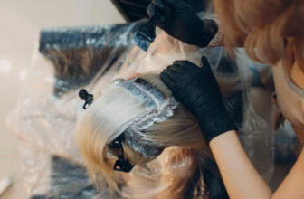 woman hairdresser dying hair at salon